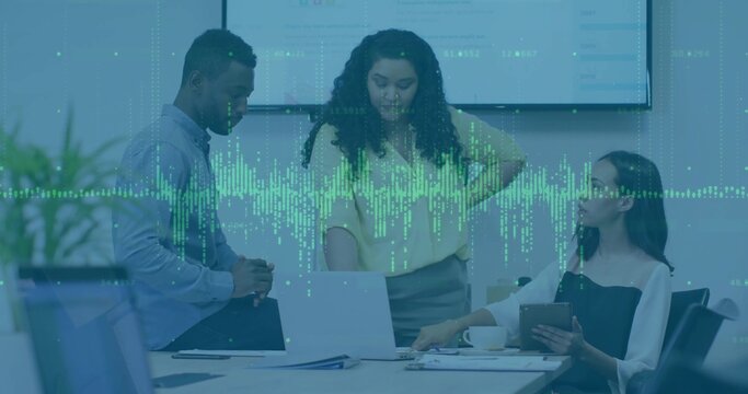 Collaborating business professionals analyzing laptop, tablet data in office with waveform overlay