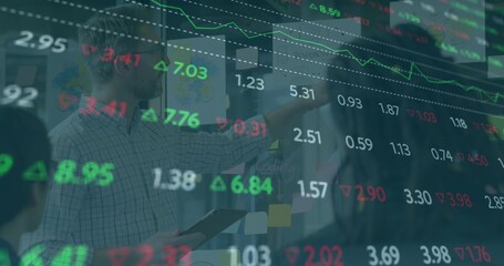 Three professionals collaborating in conference area with tablet and display of stock figures