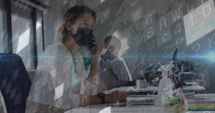 Talking woman wearing mask using smartphone and typing on laptop at open office, with data overlays