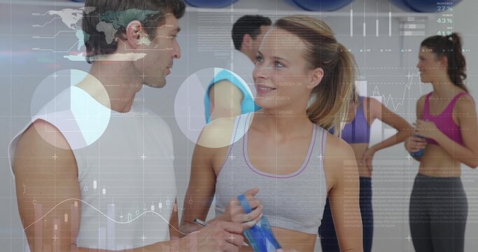 Fototapeta Two participants in sportswear talking in fitness studio with blue water bottles, exercise balls