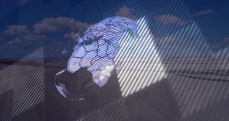 Showing holographic globe above dunes, overlaying triangular grid and diagonal stripes among clouds