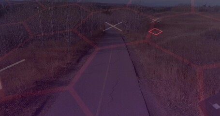 Obraz premium Stretching cracked asphalt road toward horizon in open grassland, with faded yellow center line