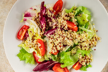 Quinoa salad tomato, green leaf salad vegetables dish natural product tasty snack fresh gourmet food background on the table rustic top view copy space keto and paleo diet vegan and vegan food