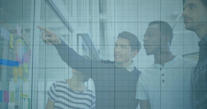 Colleagues collaborating on planning in office, with sticky notes on glass panel and grid overlay