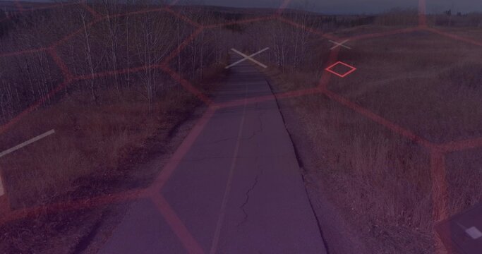 Stretching cracked asphalt road toward horizon in open grassland, with faded yellow center line - Powered by Adobe