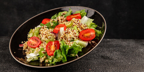 Quinoa salad tomato, green leaf salad vegetables dish natural product tasty snack fresh gourmet food background on the table rustic top view copy space keto and paleo diet vegan and vegan food