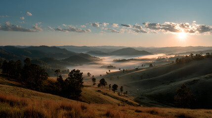 Sunrise over rolling hills with morning fog and a beautiful sky