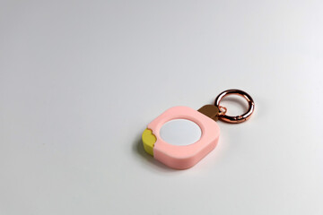 Pastel pink ice cream-shaped location tracker keychain for safety and style