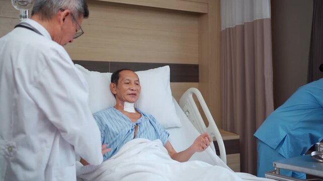 Doctor and nurse checking elderly tracheostomy patient in hospital.