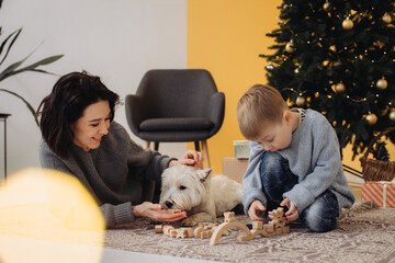 Family enjoying christmas holiday with pet dog