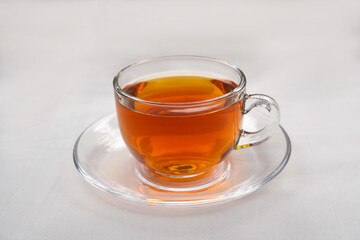 A glass cup of red tea isolated on white background. Healthy herbal drink. Side view and Selective focus.
