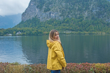 Tourist Lady Exploring Austrian Lake, Yellow Jacket Travel Concept