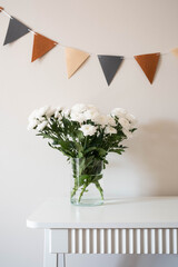 Gracefully arranged elegant white flowers accompanied by a decorative bunting banner