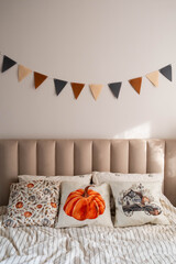 Enjoy a warm and inviting bedroom with charming autumn pillows and cozy bedding for a relaxing experience.