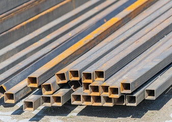 Stacked square steel pipes with rust