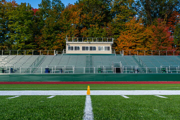 Photo of the exterior of a press box with roof video platform, from field level.
