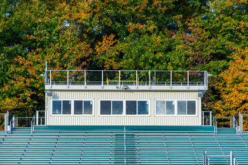 Photo of the exterior of a press box with roof video platform, from field level.
