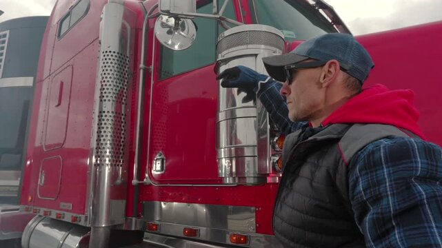 Trucker Inspects Rig at a Rest Stop During Cloudy Day