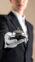 Woman in uniform holding a service bell