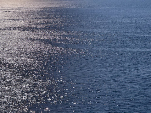 Ocean blue glittering water surface.