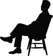 Silhouette of a Man Sitting and Relaxing in a Chair While Waiting