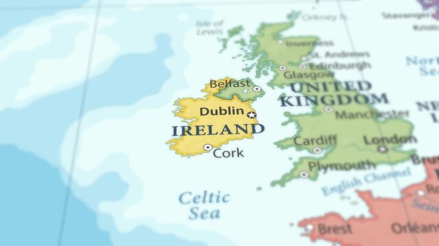 4K macro footage of Ireland on a world map with shallow depth of field. Focus on word Ireland and nearby regions. Travel geography footage