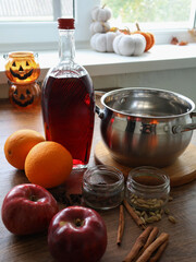 Still life with wine, apples, oranges and spices.