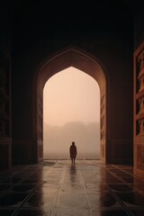 Serene Figure Silhouetted in Majestic Archway at Sunrise with Misty Landscape in Background