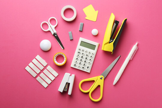 Stapler and other stationery on pink background, flat lay - Powered by Adobe