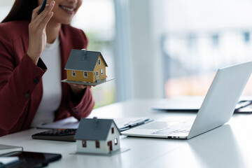 professional evaluates home loan and house contract and valuation at office desk