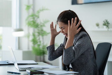  woman appears sad and exhausted while working with stressful in office