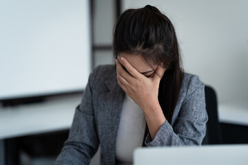 woman feels stressed and tired handling documents with a sad expression