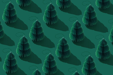 Paper Christmas tree Ornaments, hanging green New Year decorations. Minimal aesthetic holidays pattern, green monochrome design, repeated arrangement, top view background of craft winter xmas bauble