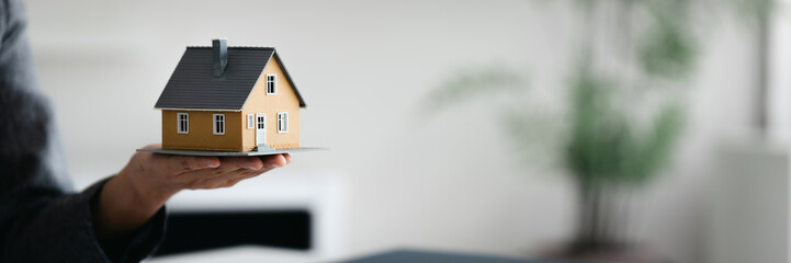 Hand hold house model, real estate and property concept