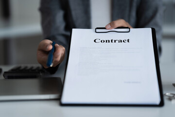Lawyer preparing to sign a contract reading documents