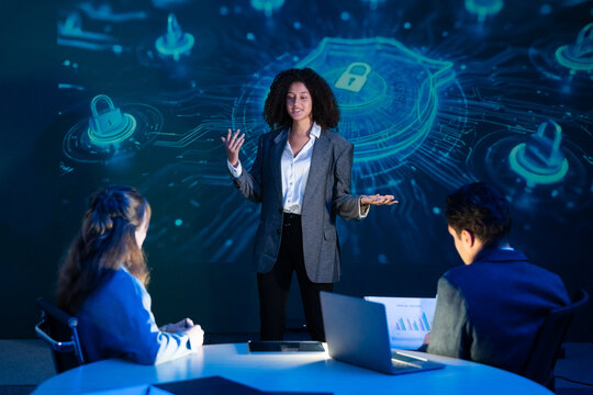 Cybersecurity expert leading a strategy meeting, presenting on data protection, network security, and privacy to her team. - Powered by Adobe