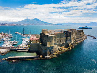 Castel dell'Ovo, Naples, Italy - aerial view of the castle with Mount Vesuvius in the background