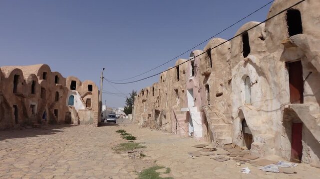 Walking through neglected historic ksar complex (partly used as a storage facility for the local bazaar) in city of Medenine, Tunisia
