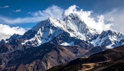 Majestic mountain range with snow-capped peaks under a vibrant blue sky