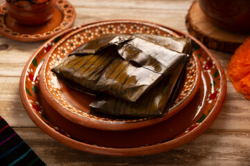 Oaxacan Tamales. A pre-Hispanic dish typical of Mexico and some Latin American countries. Corn dough wrapped in banana leaves is filled with meat or a stew. Tamales are steamed.