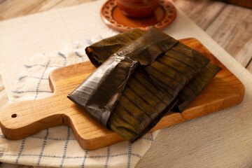 Oaxacan Tamales. A pre-Hispanic dish typical of Mexico and some Latin American countries. Corn dough wrapped in banana leaves is filled with meat or a stew. Tamales are steamed.