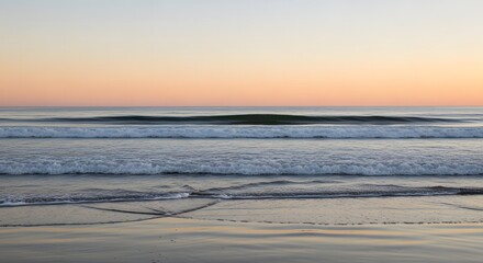 Serene ocean waves gently lapping on a sandy shore at sunset