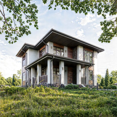 Contemporary two-story home with terrace surrounded by lush greenery and blue sky.