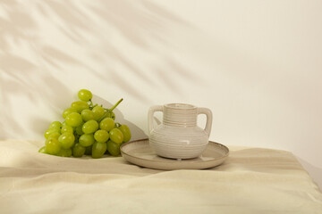 modern Light homemade still life - ripe juicy green grapes in a white bowl on the table in a bright room