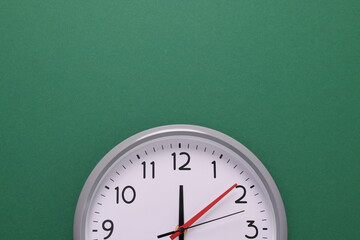 Close-up of a wall clock. The concept of time and work time is valuable for life, Alarm clock stopped. photo in a coloured background