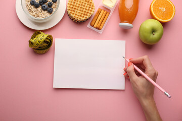 Making a meal plan for several days. Concept of healthy lifestyle, sports and daily routine. Notebook, marker, dumbbells, fruit healthy food, centimetre. Diet plan. Top view, horizontal.