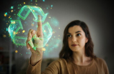 Woman interacting with holographic recycling symbol in digital environment