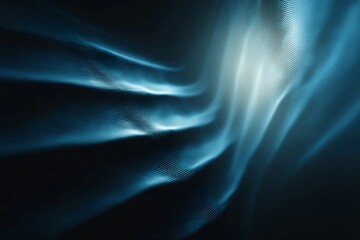 Fototapeta premium Flowing blue waves create a calming and abstract visual effect in a dark background