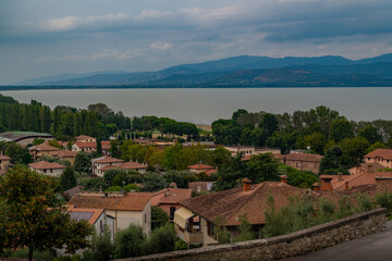 Rooftop Village and Lake View with Distant Blue Mountains, Italy