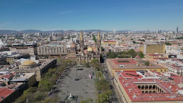 Aerial footage advancing above Plaza Tapatia in Guadalajara, Jalisco, showing the iconic cathedral, plaza, and urban skyline around it